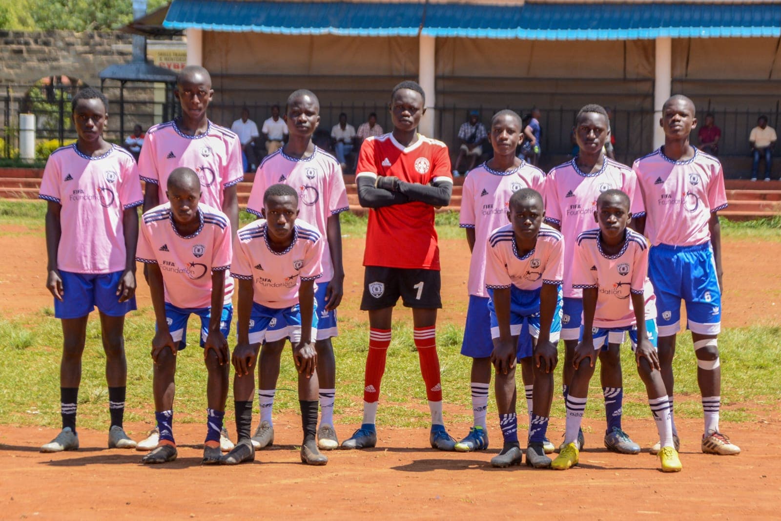 Youth football team in pink FIFA Foundation kits